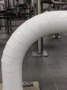 Curved white industrial pipe